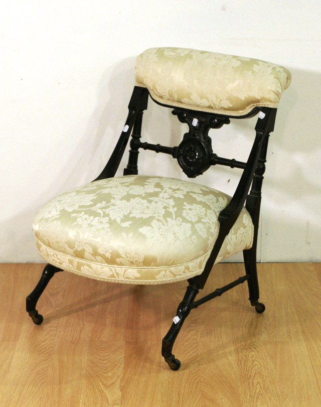 Appraisal: A late Victorian ebonised and upholstered nursing chair in the