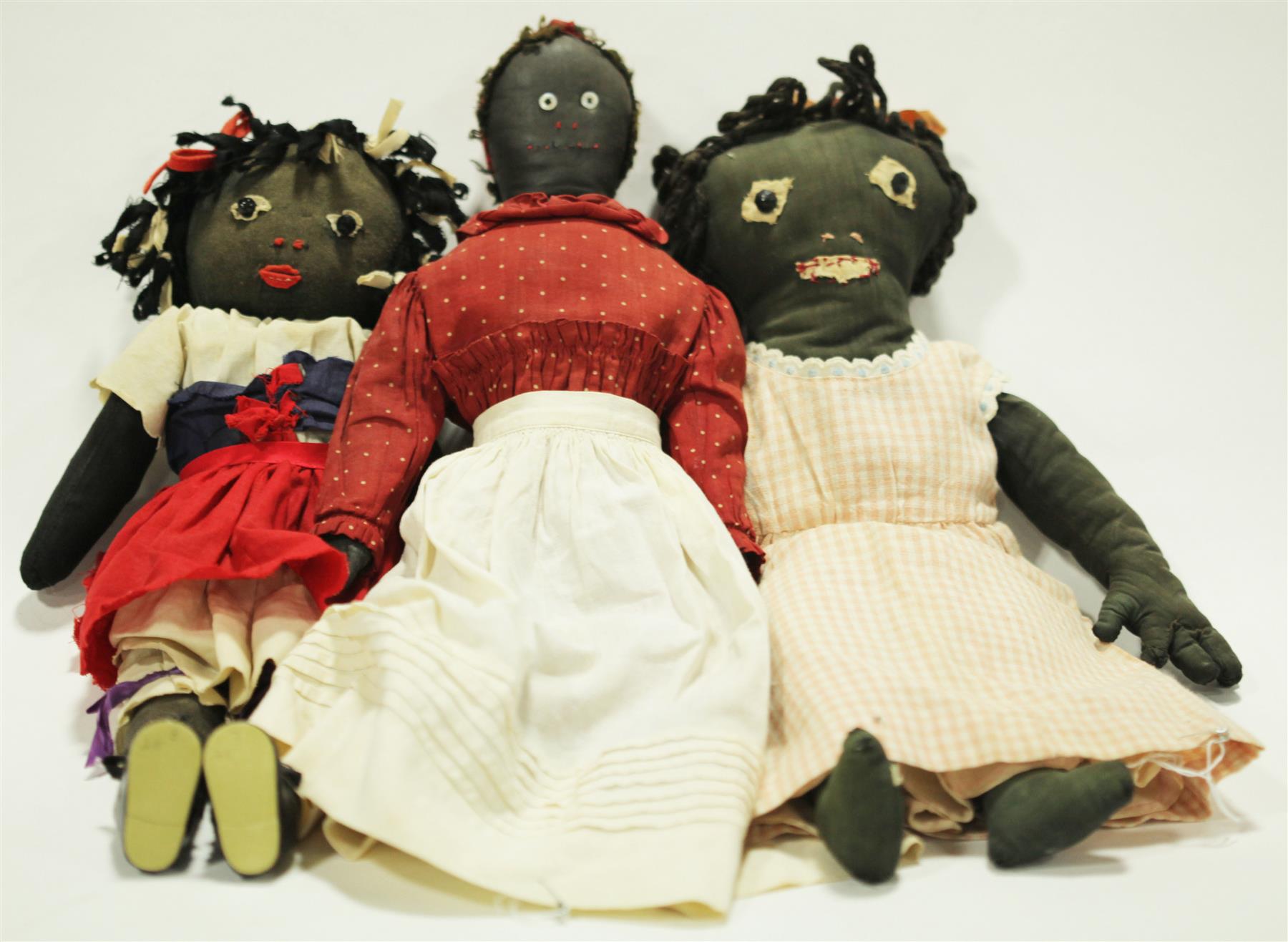 Appraisal: THREE EARLY BLACK CLOTH DOLLS Late th-early th century All