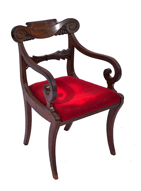 Appraisal: A LATE REGENCY MAHOGANY ELBOW CHAIR with scroll carved bar