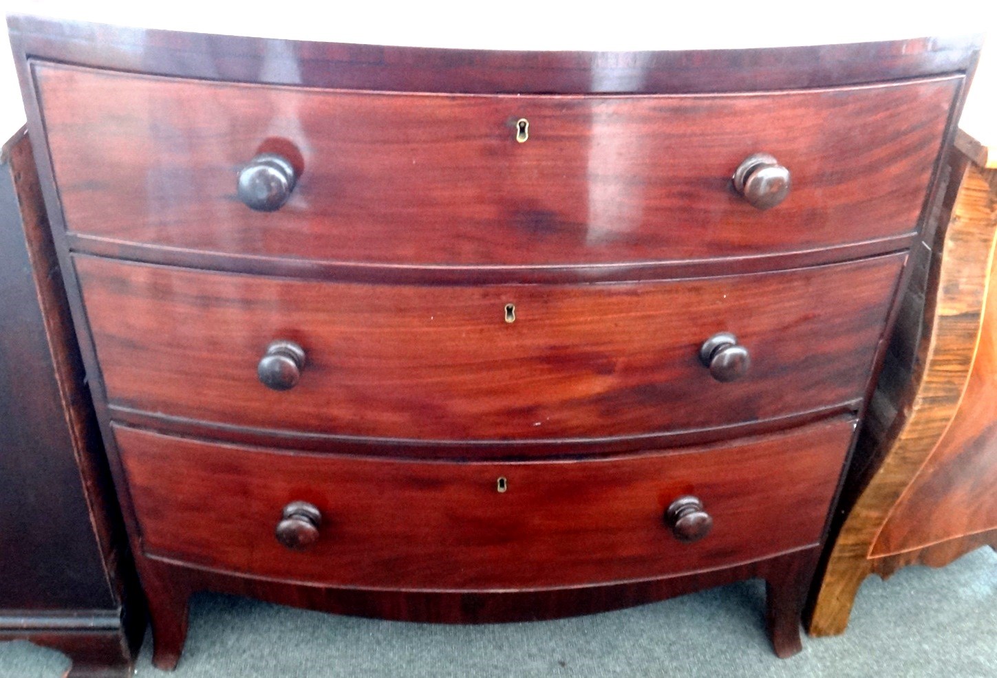 Appraisal: A th century mahogany bowfront chest of three long graduated