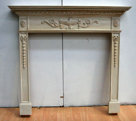 Appraisal: A white painted pine fireplace surround in the Adam style