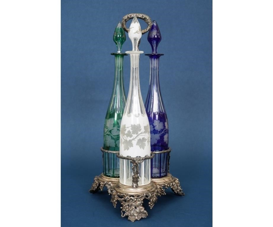 Appraisal: Silver plate decanter stand with three colored glass cut to