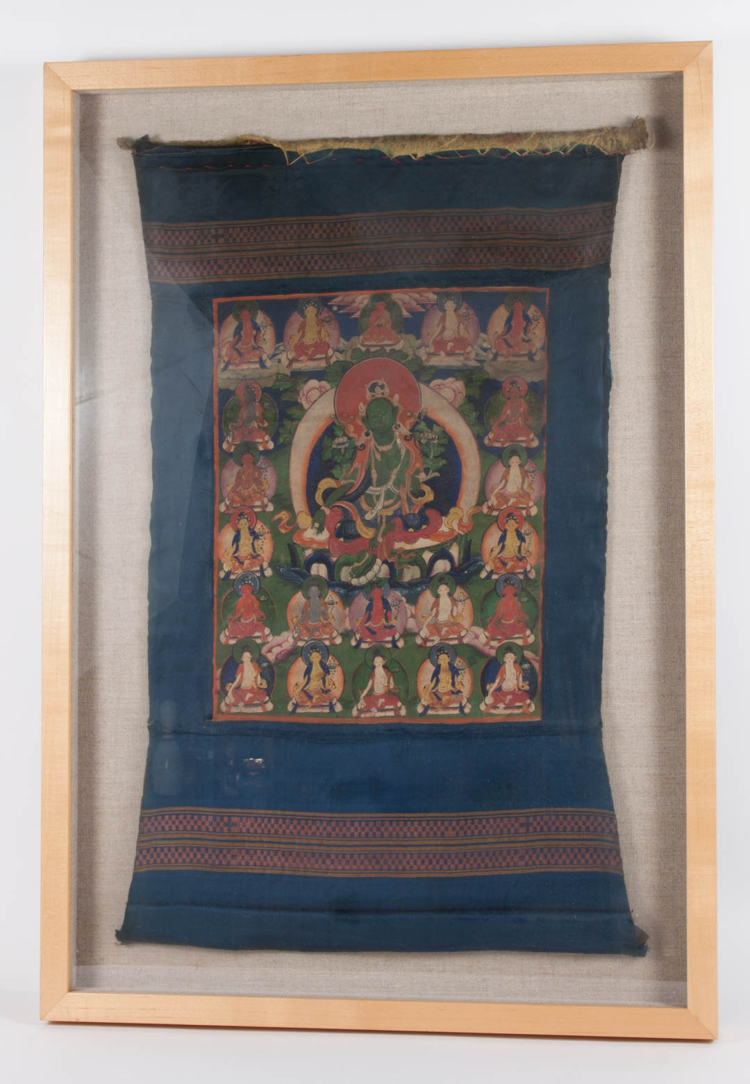 Appraisal: Diminutive Tibetan Thangka th century tempera on cloth in shadowbox