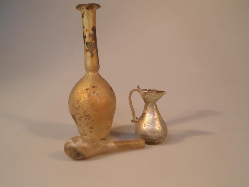 Appraisal: A golden iridescent Roman glass unguentarium with a repaired mouth