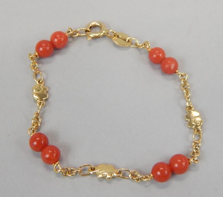 Appraisal: An ct gold coral christening bracelet with coral beads and