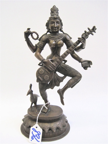 Appraisal: A SINO-TIBETAN BRONZE FIGURE OF A MULTI-ARMED DEITY standing on