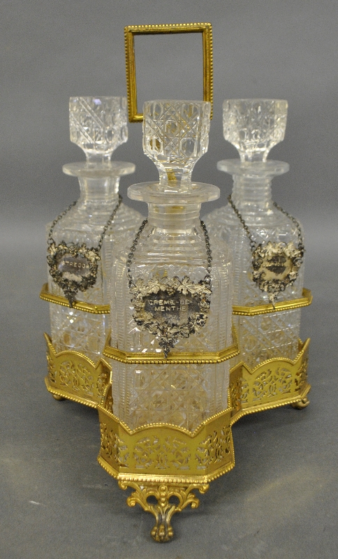 Appraisal: - English gold wash over plate decanter stand with three