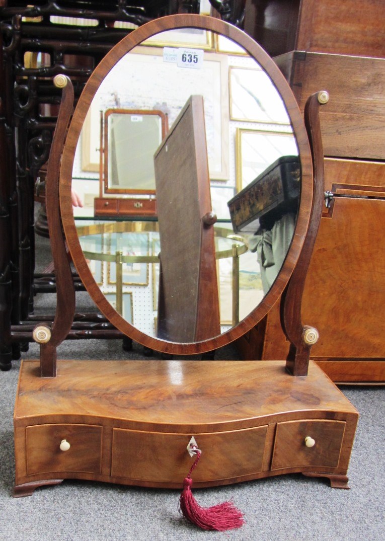 Appraisal: A th century mahogany toilet mirror with serpentine three drawer