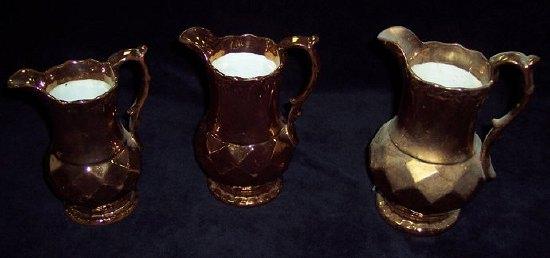 Appraisal: Three graduated copper lustre jugs