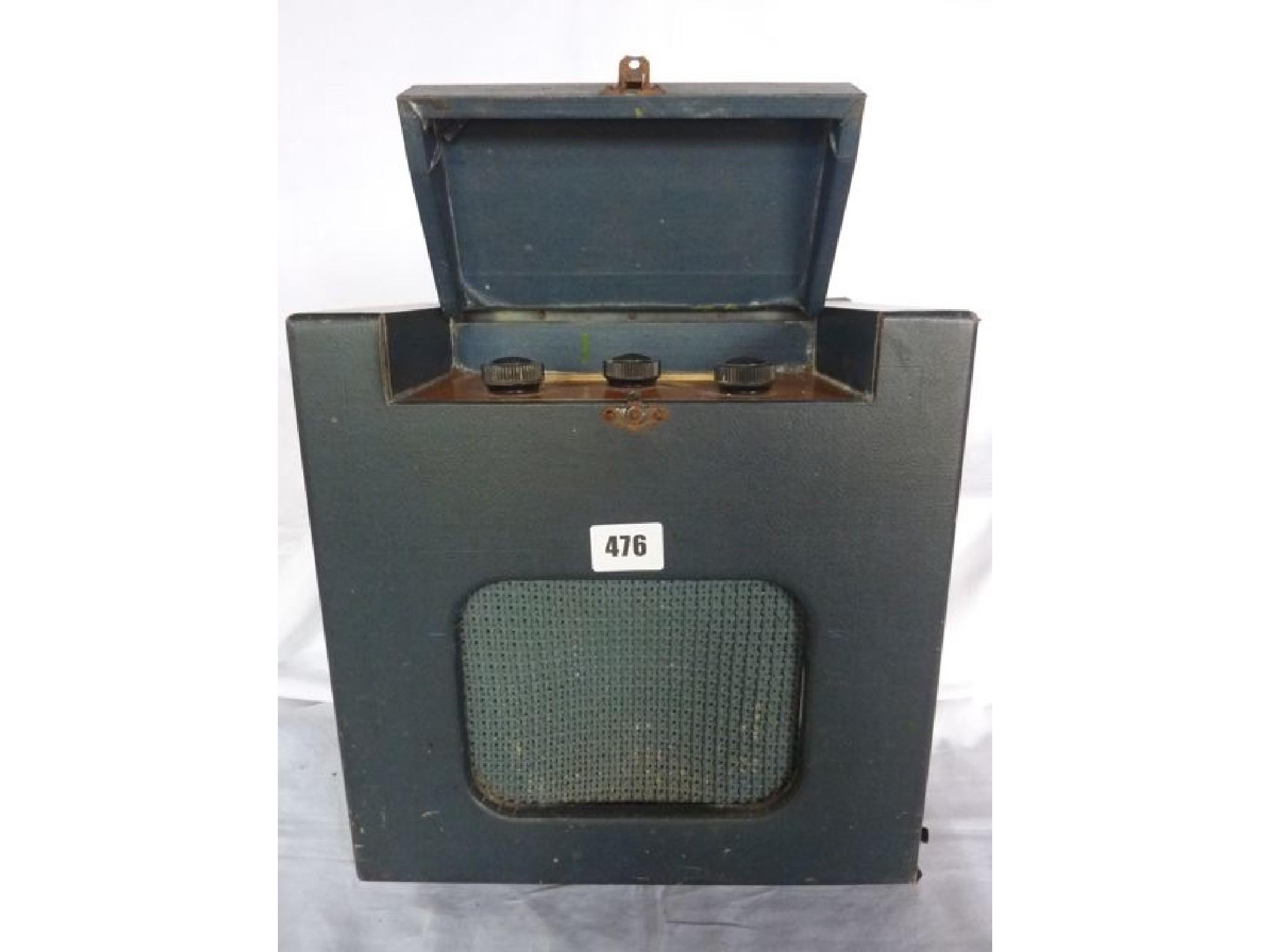 Appraisal: A vintage portable radio in a green cloth case