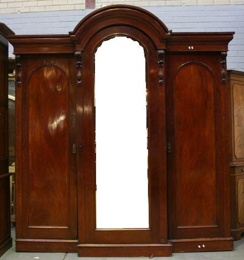 Appraisal: A Victorian mahogany wardrobe with central arched mirrored door cm