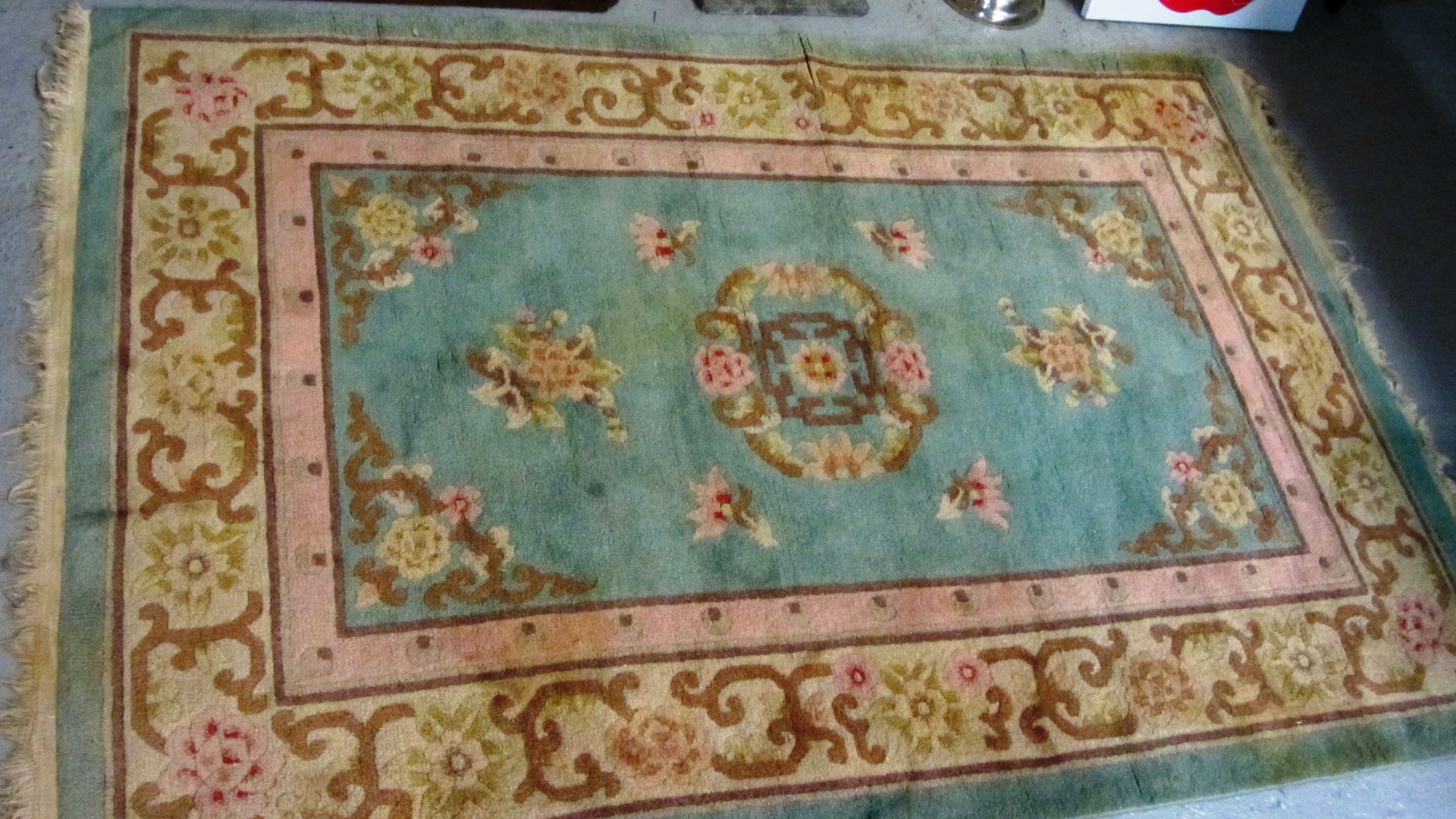 Appraisal: A Chinese rug the pale turquoise field with a floral