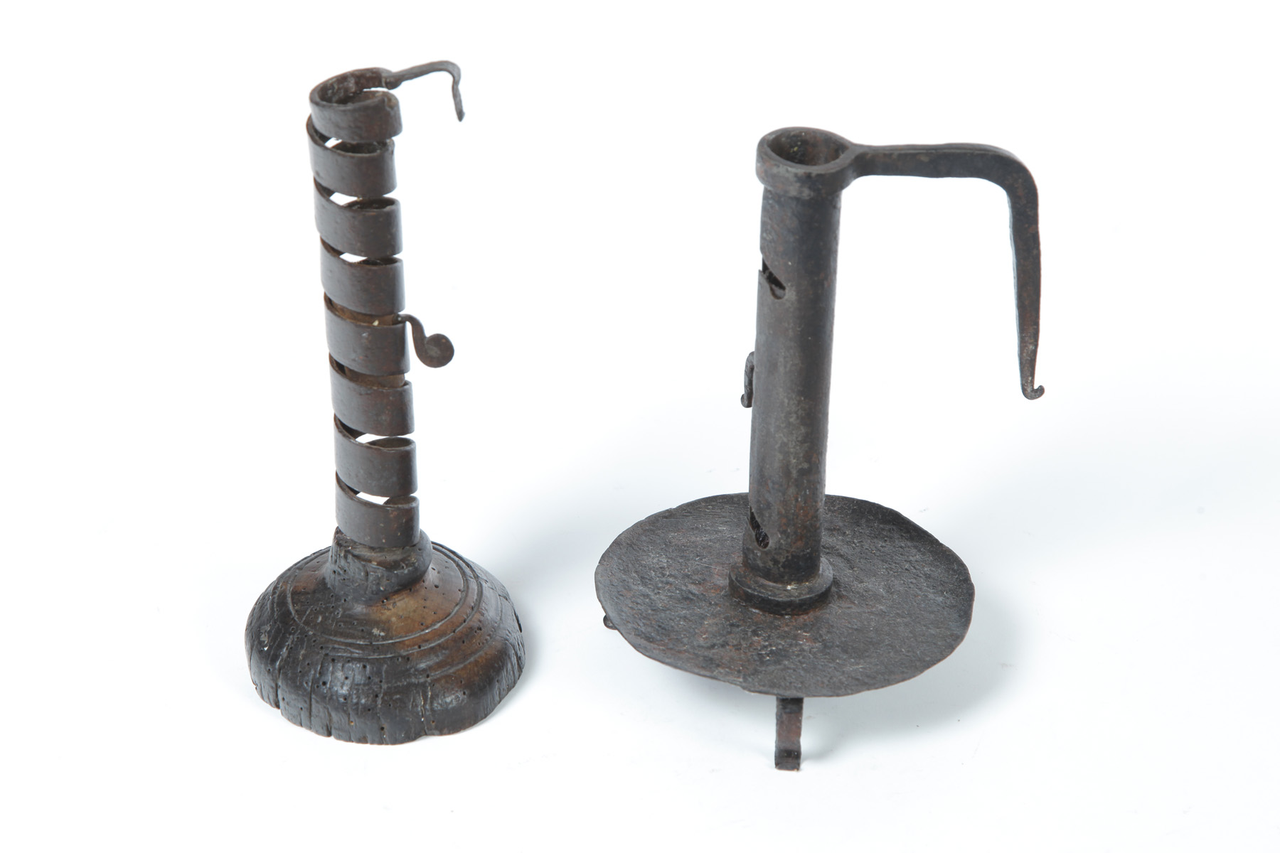 Appraisal: TWO WROUGHT IRON CANDLESTICKS Eighteenth century English spiral candlestick with