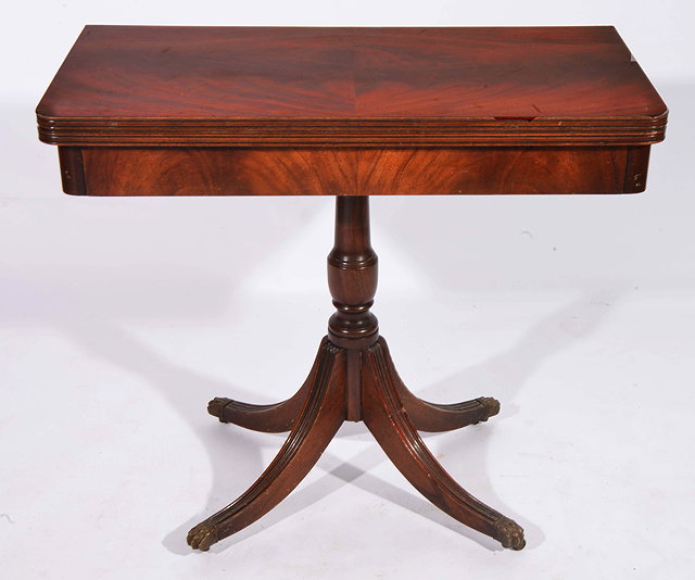 Appraisal: A REGENCY STYLE MAHOGANY FOLD OVER CARD TABLE with central