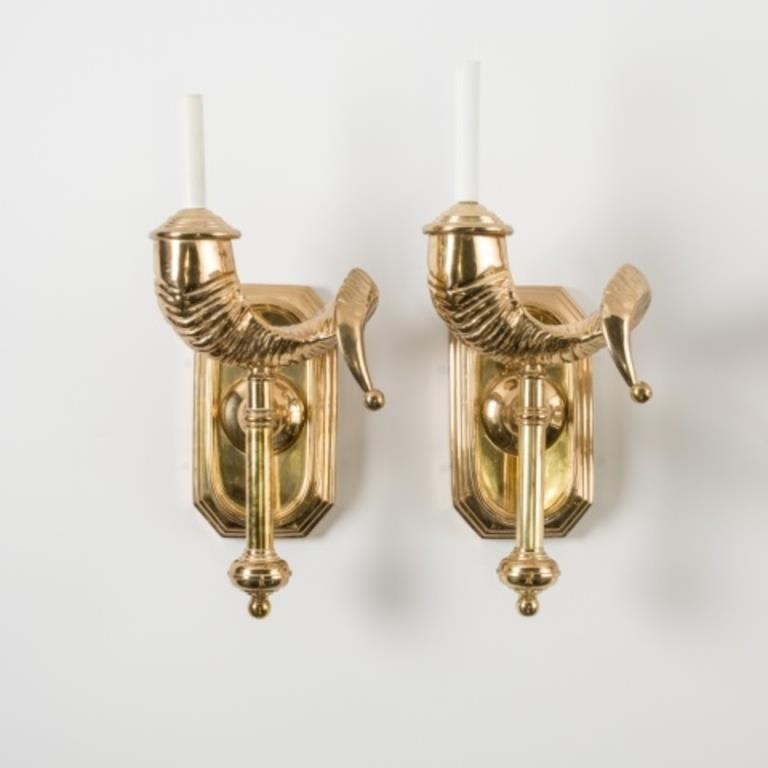 Appraisal: A pair of brass ram's horn-shaped wall sconces mounted to