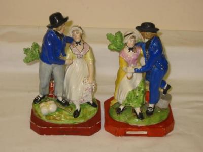 Appraisal: A PAIR OF STAFFORDSHIRE POTTERY FIGURES Departure and Return modelled