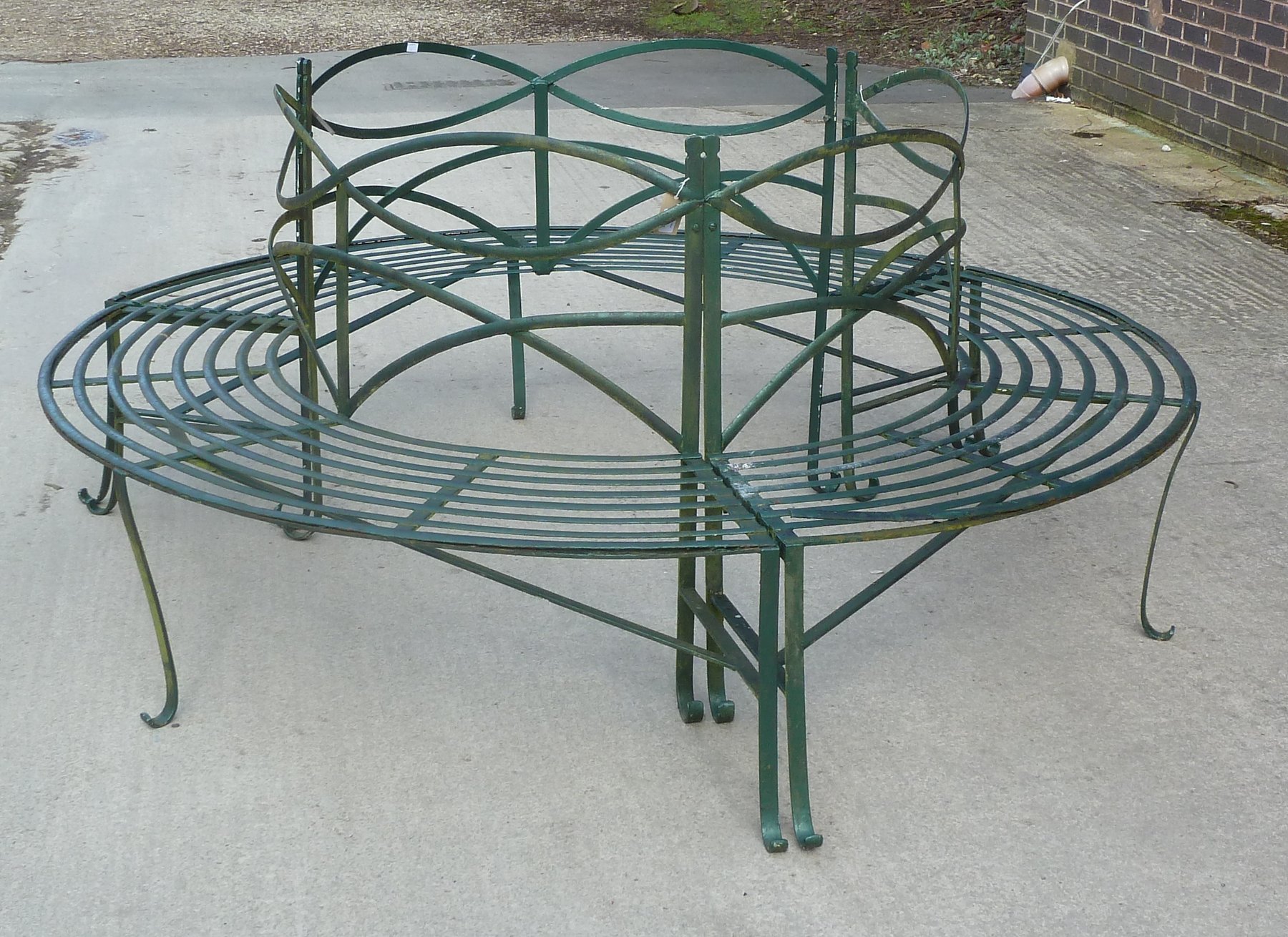 Appraisal: A wrought iron tree seat in three sections