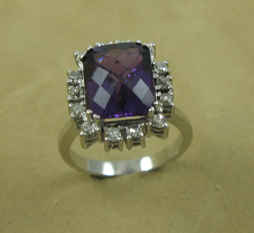 Appraisal: A FANCIFUL LADY'S AMETHYST-DIAMOND RING The large cushion-cut rectangular amethyst