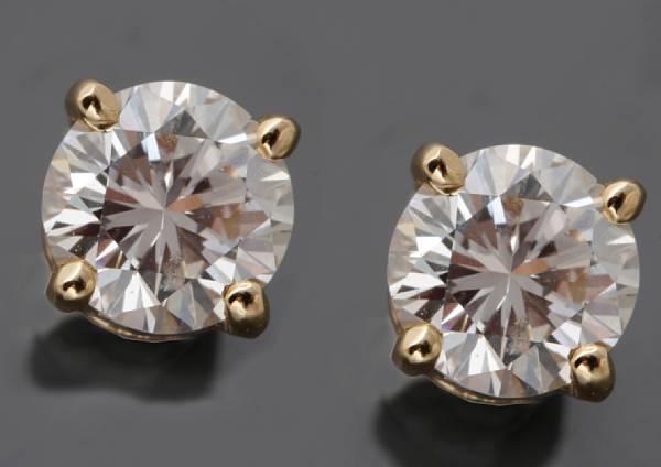 Appraisal: A pair of diamond studs estimated total diamond weight ct