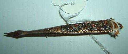 Appraisal: A gilt metal turban pin possibly set with rough cut