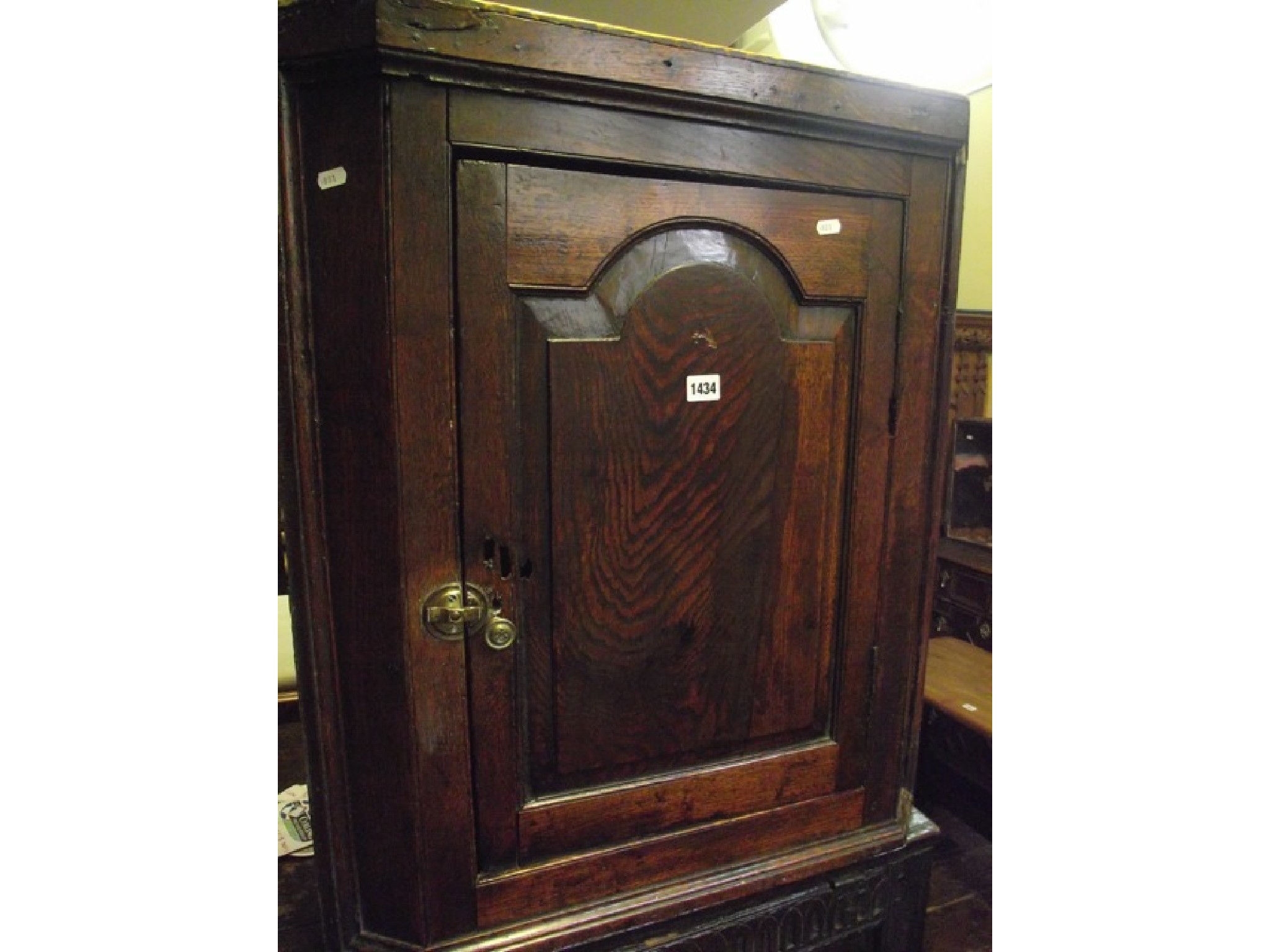 Appraisal: A Georgian oak cottage hanging corner cupboard the panelled door