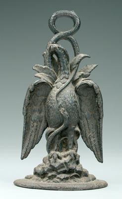 Appraisal: Cast iron eagle doorstop eagle perched on rocks intertwined with