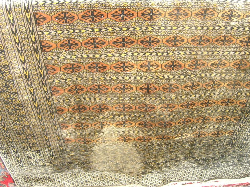 Appraisal: A grey ground eastern wool rug with repeating gul motifs