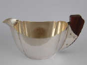 Appraisal: A s style cream jug with rosewood handle unmarked tests