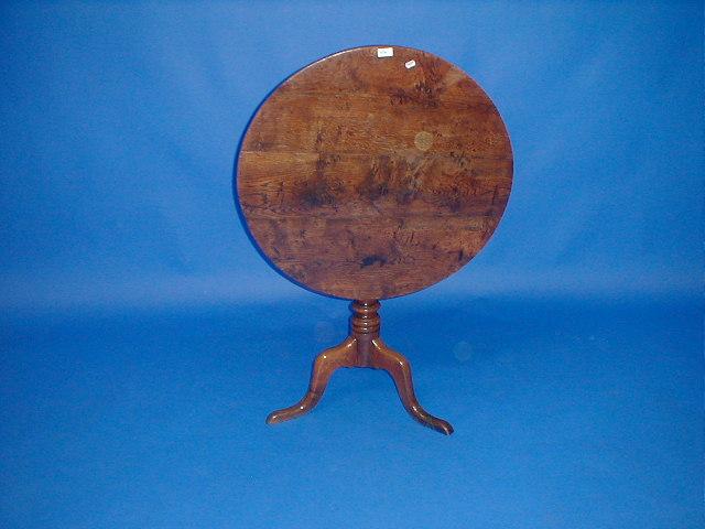 Appraisal: A George III elm supper table with circular tilt top