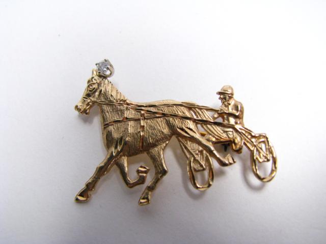 Appraisal: k yellow gold chariot race motif pin with diamond accent