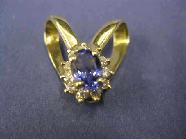 Appraisal: Tanzanite Diamond Pendant fine richoval gem weighing carat surrounded by