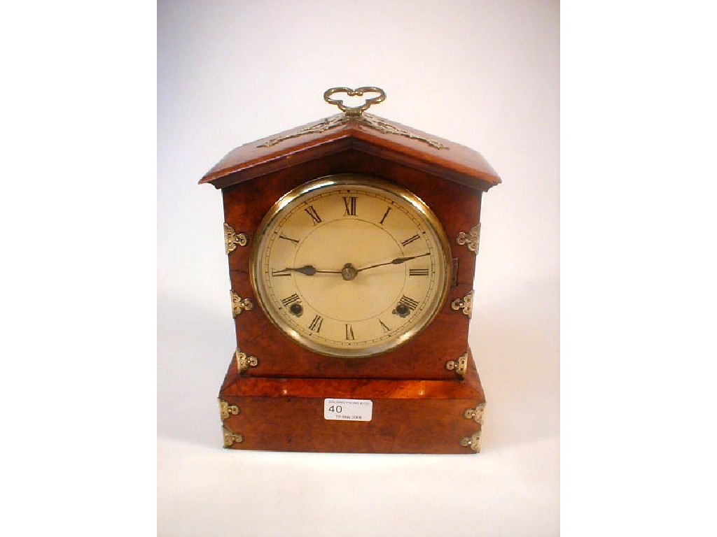 Appraisal: A Victorian burr walnut mantel clock with brass strap work