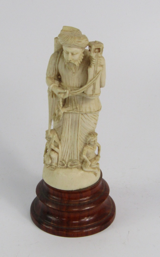 Appraisal: An Indian ivory carving of a musician modelled standing with