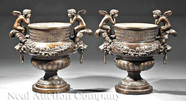 Appraisal: A Pair of Patinated Bronze Campagna Urns featuring cherubs atop