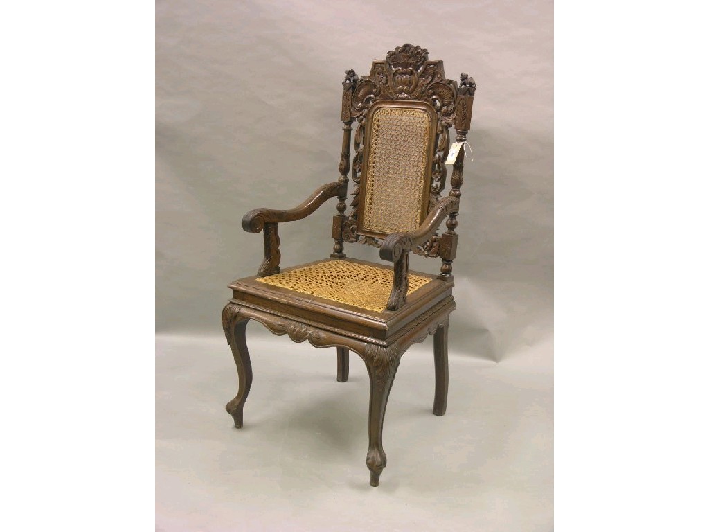 Appraisal: A carved oak elbow chair with caned seat and back