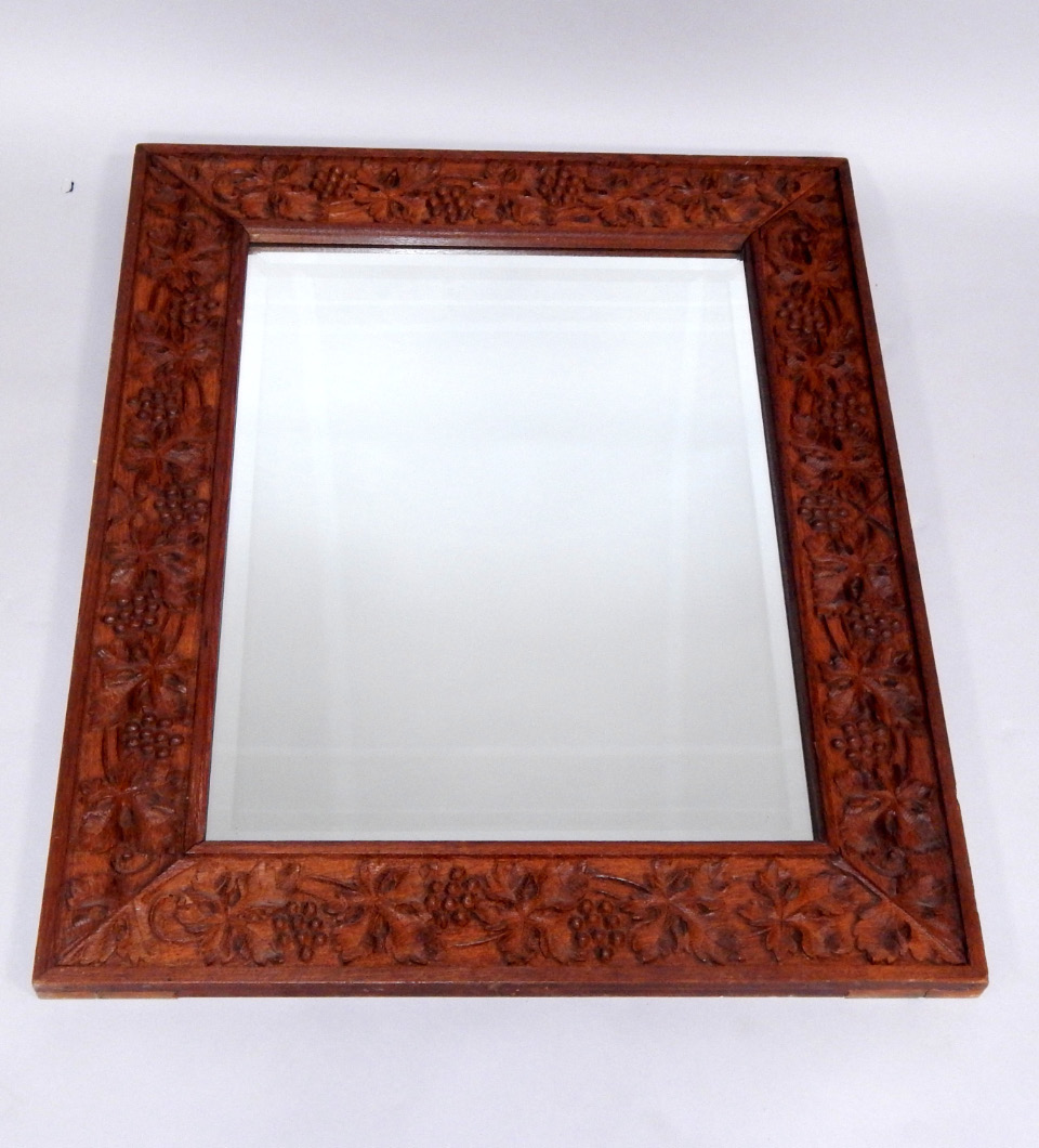 Appraisal: An oak framed rectangular wall mirror carved with vines cm