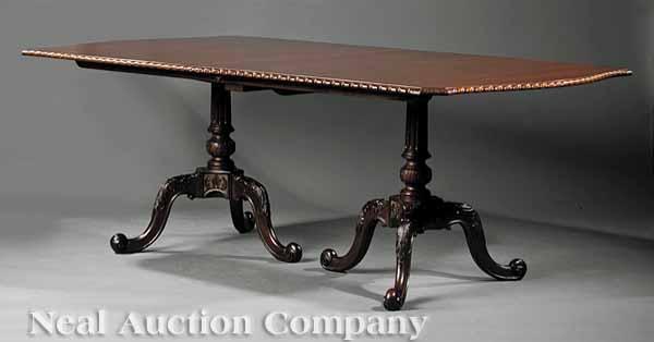 Appraisal: A Regency-Style Carved Mahogany Banquet Table the shaped top with