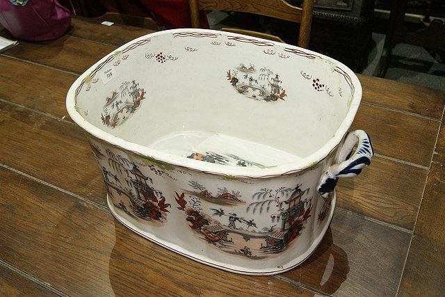 Appraisal: A VICTORIAN OVAL POTTERY FOOTBATH with Chinese style decoration