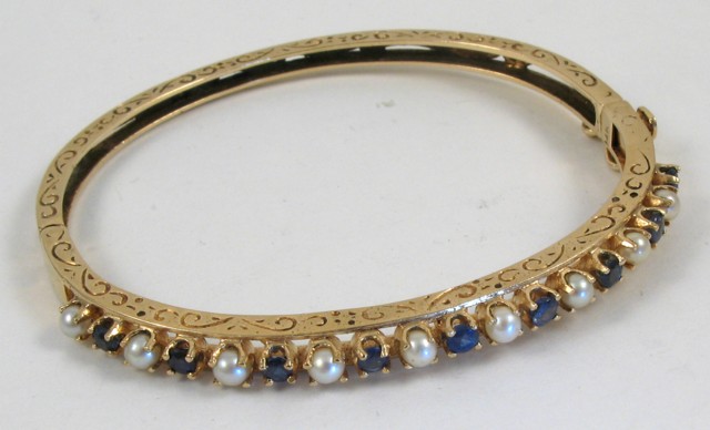 Appraisal: SAPPHIRE AND PEARL BANGLE k yellow gold bangle set with