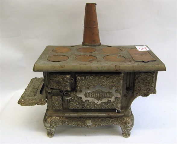 Appraisal: TRIUMPH CAST IRON COPPER MINIATURE COOK STOVE th century in