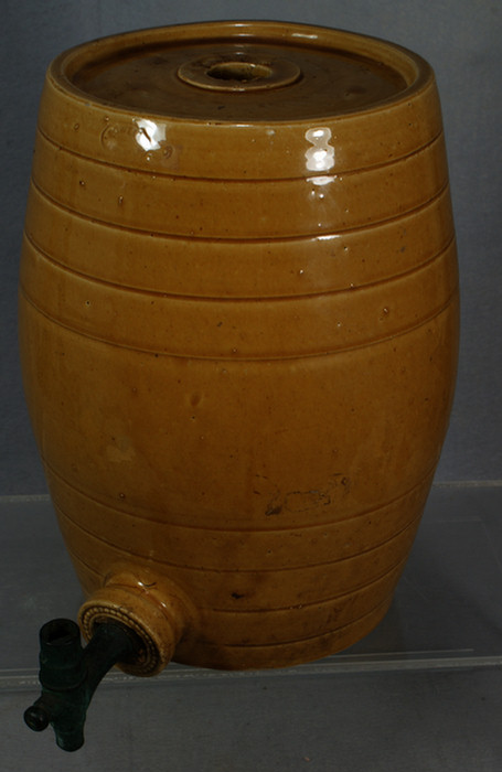 Appraisal: English tan glazed stoneware keg brass and wood spigot signed