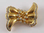 Appraisal: A yellow metal tests carat gold diamond bow brooch approx