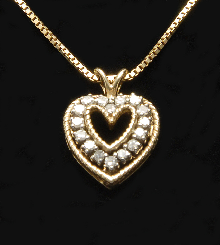 Appraisal: KT YELLOW GOLD AND DIAMOND PENDANT NECKLACE In heart shape