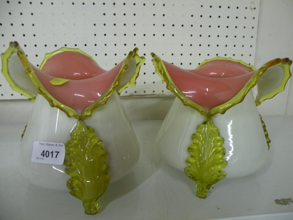 Appraisal: A pair of Victorian vaseline pink and cream opaque glass