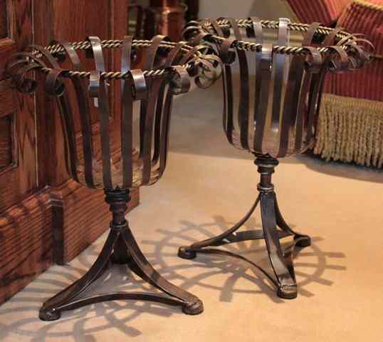 Appraisal: A PAIR OF WROUGHT IRON STRAP WORK PLANT STANDS on