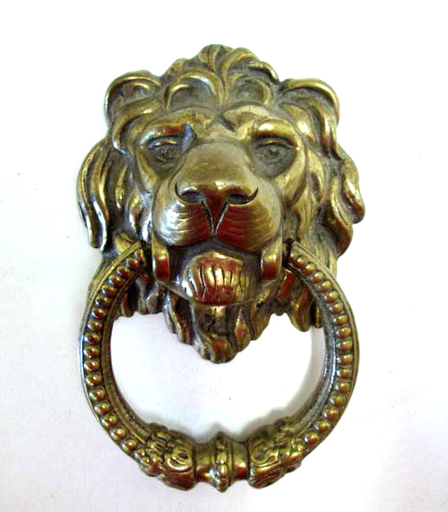 Appraisal: BRASS LION HEAD DOOR KNOCKER lion head mask holding decorative