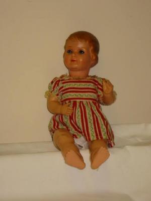 Appraisal: A German celluloid girl doll with blue sleeping eyes moulded