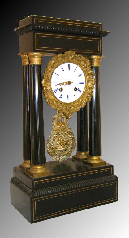 Appraisal: French Empire style ebonised two train portico mantel clock the