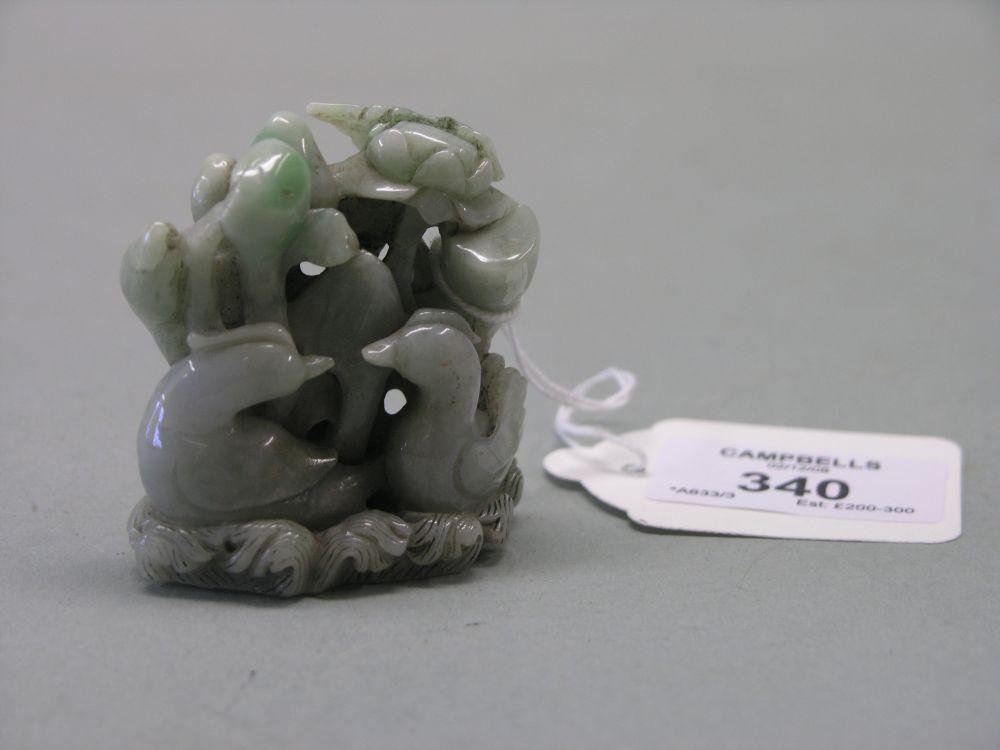 Appraisal: A Chinese green jade carving ducklings and plant life on