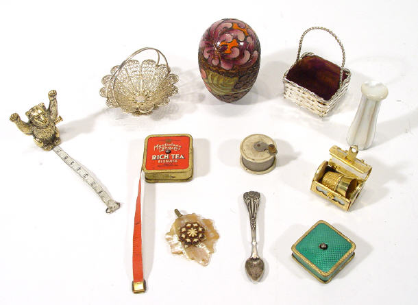 Appraisal: Group of sewing items including advertising sewing tape measure casket